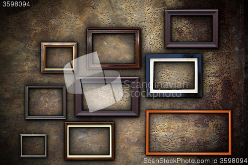 Image of picture frames on abstract rusty wall