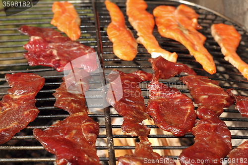 Image of beef and salmon left to smoke