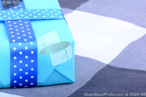 Image of blue gift box with white ribbon