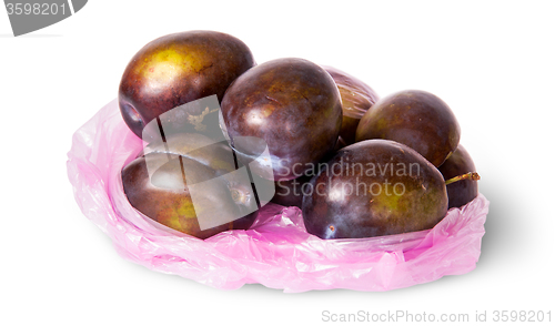 Image of Whole violet plums in plastic bag