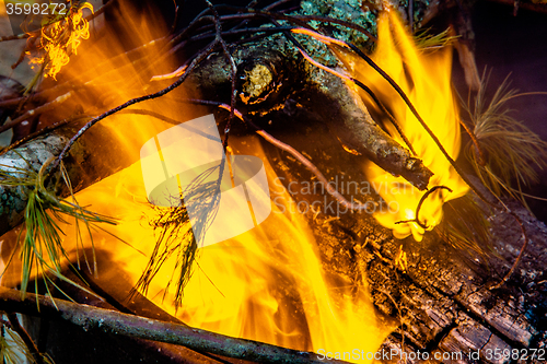 Image of camp fire flames burning at night after hike