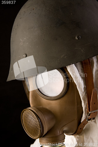 Image of Military person in gas mask and helmet