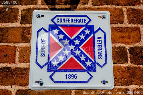 Image of confederate flag plaque attached to brick wall