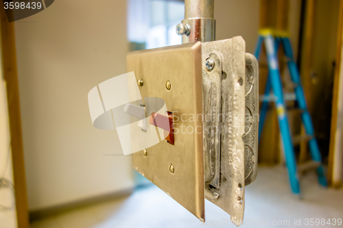 Image of light switch ready to get enclosed into wall during construction