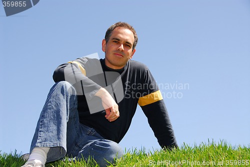 Image of Man sitting on grass