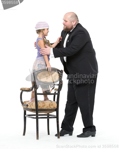 Image of Little Girl and Servant in Tuxedo Have Fun