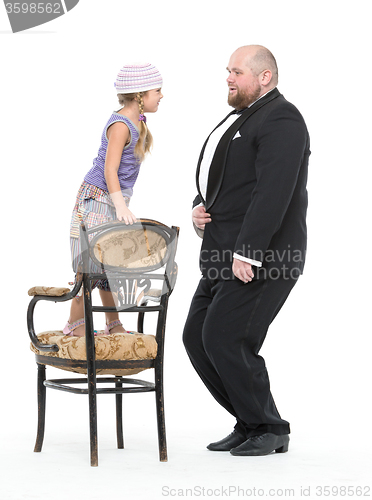 Image of Little Girl and Servant in Tuxedo Have Fun