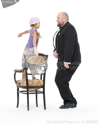 Image of Little Girl and Servant in Tuxedo Have Fun