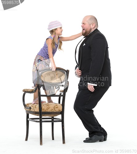 Image of Little Girl and Servant in Tuxedo Have Fun