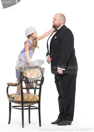 Image of Little Girl and Servant in Tuxedo Have Fun