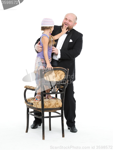 Image of Little Girl and Servant in Tuxedo Have Fun