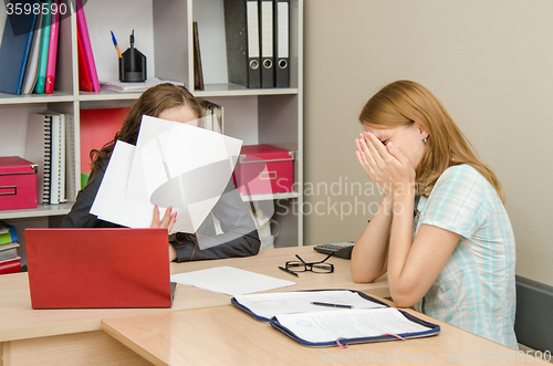 Image of The girl was crying at the reception office worker covered his face with papers