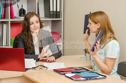 Image of Girl shows HR specialist diplomas which she does not want to look