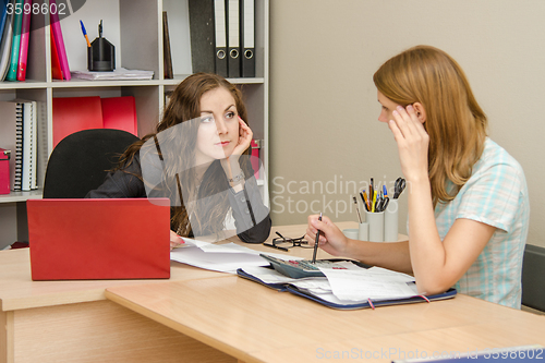 Image of Two women talking in the office and dealt with in the accounts