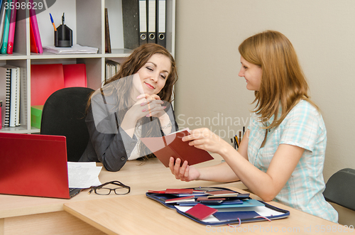 Image of A young girl shows Diplomas office worker