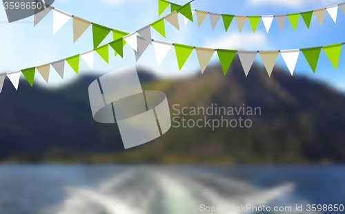 Image of Party flags celebrate abstract background and mountain landscape