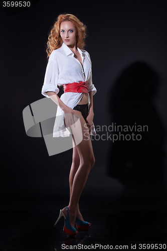 Image of Young Red- Haired Woman In White Shirt