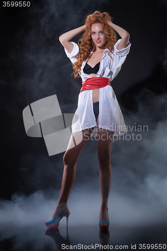 Image of Young Red- Haired Woman In White Shirt
