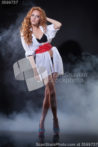 Image of Young Red- Haired Woman In White Shirt