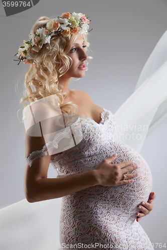 Image of Young Pregnant Woman With Flower Garland