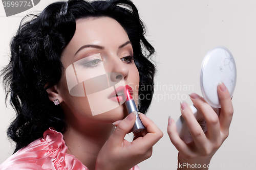 Image of Young Woman Applying Cosmetics