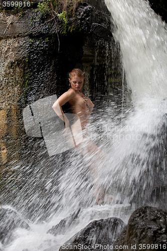 Image of Young Nude Woman Swimming