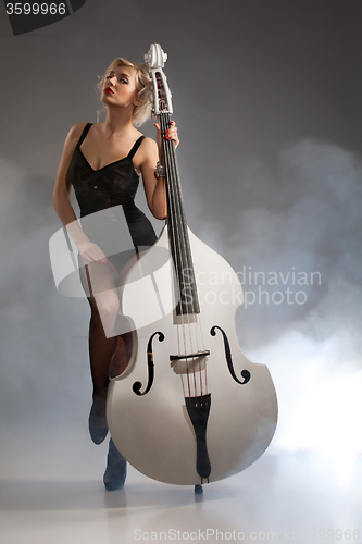 Image of Young Woman In Lingerie With A Double Bass