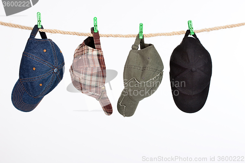 Image of Four Caps On A Clothesline