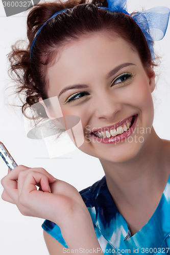 Image of Young Woman Applying Cosmetics