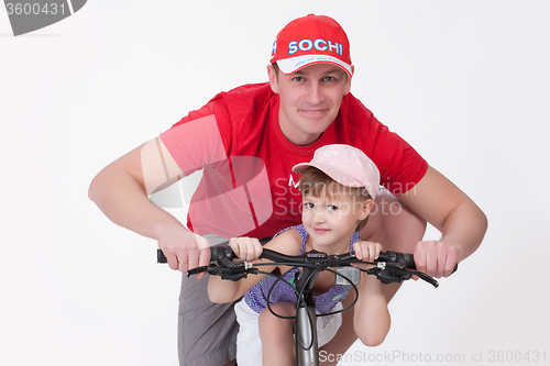 Image of Father And Daughter On The Bicycle