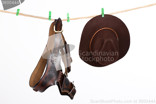 Image of Cowboy Hat and Belt On A Clothesline