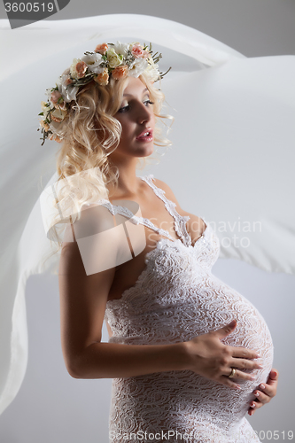 Image of Young Pregnant Woman With Flower Garland
