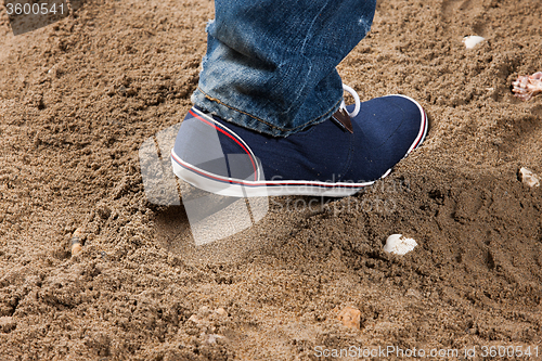 Image of Man\'s Legs And Footprint On The Sand