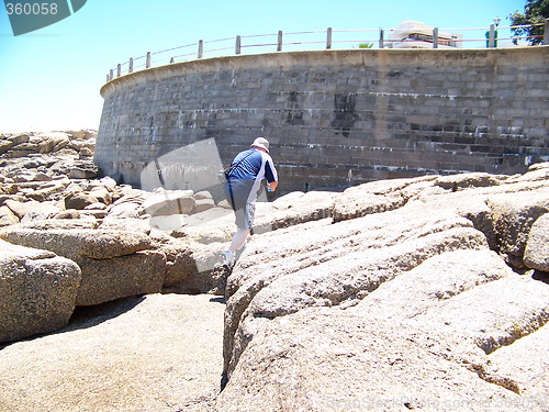 Image of Man climbing on rocks