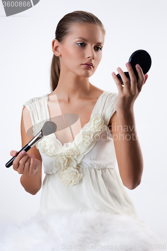 Image of Young Woman Applying Cosmetics