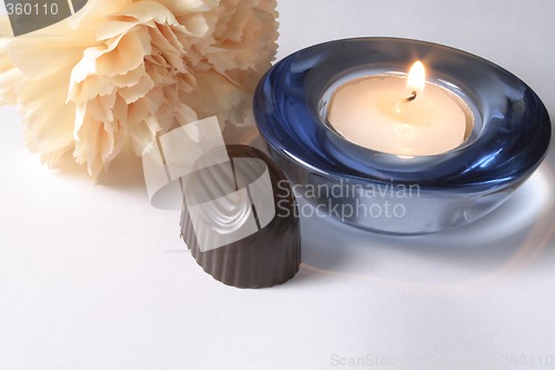 Image of chocolate and carnation with a candle