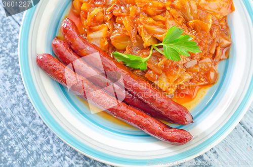 Image of sausages with fried cabbage