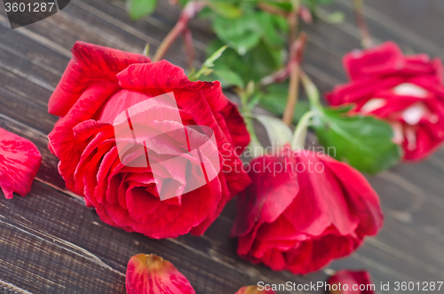Image of rose on wooden background