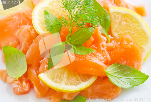 Image of fresh salmon with lemon on the white plate