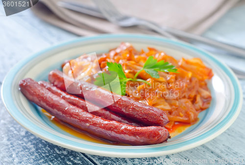 Image of sausages with fried cabbage