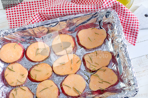 Image of sweet potato with rosemary on the foil