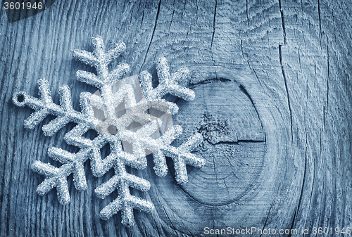 Image of Silver snowflakes on the wooden background