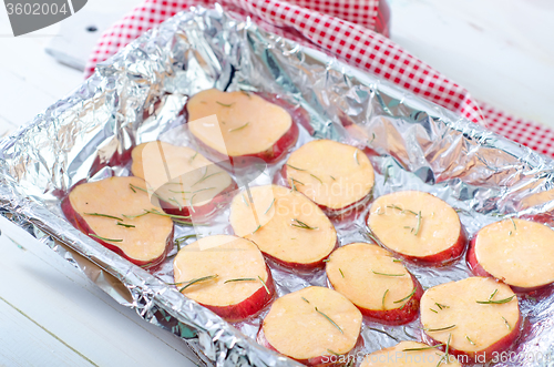 Image of sweet potato with rosemary on the foil