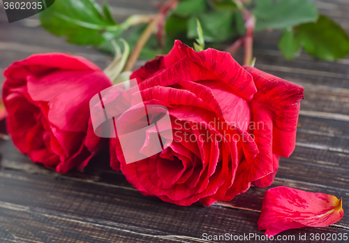 Image of rose on wooden background