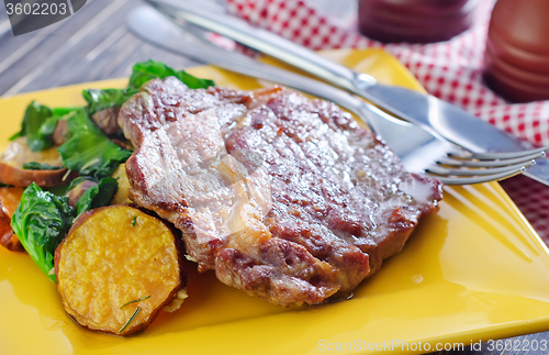 Image of baked meat and salad