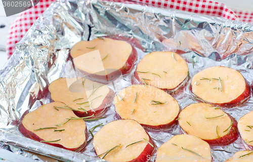 Image of sweet potato with rosemary on the foil