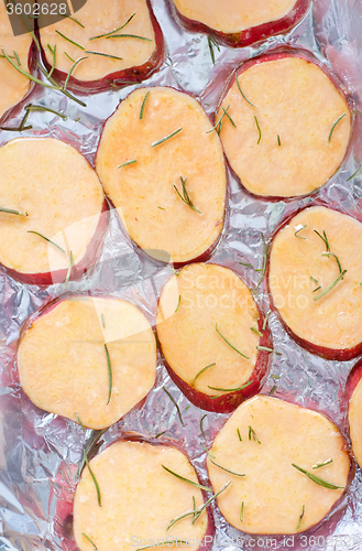 Image of sweet potato with rosemary on the foil