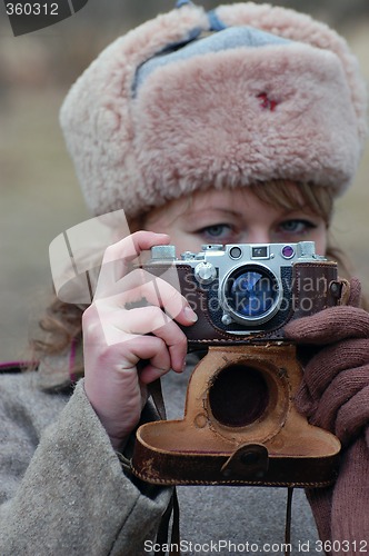 Image of Girl soldier WWII. With camera