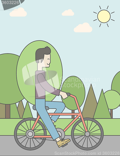 Image of Asian man riding bicycle in park.