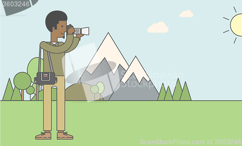 Image of Photographer taking photo in mountains